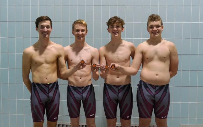 The Oskaloosa Medley Relay Team stands with their Bronze Medal. From left: Jack Miller, Jack Dawson, Carson Breon, and Owen Gordon.